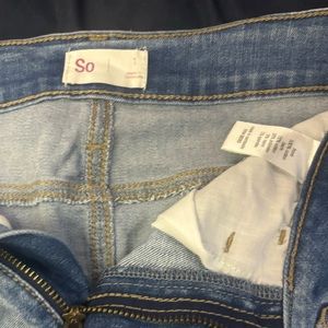 light-wash denim mini skirt, rip detail, seam down the front, fringe detail